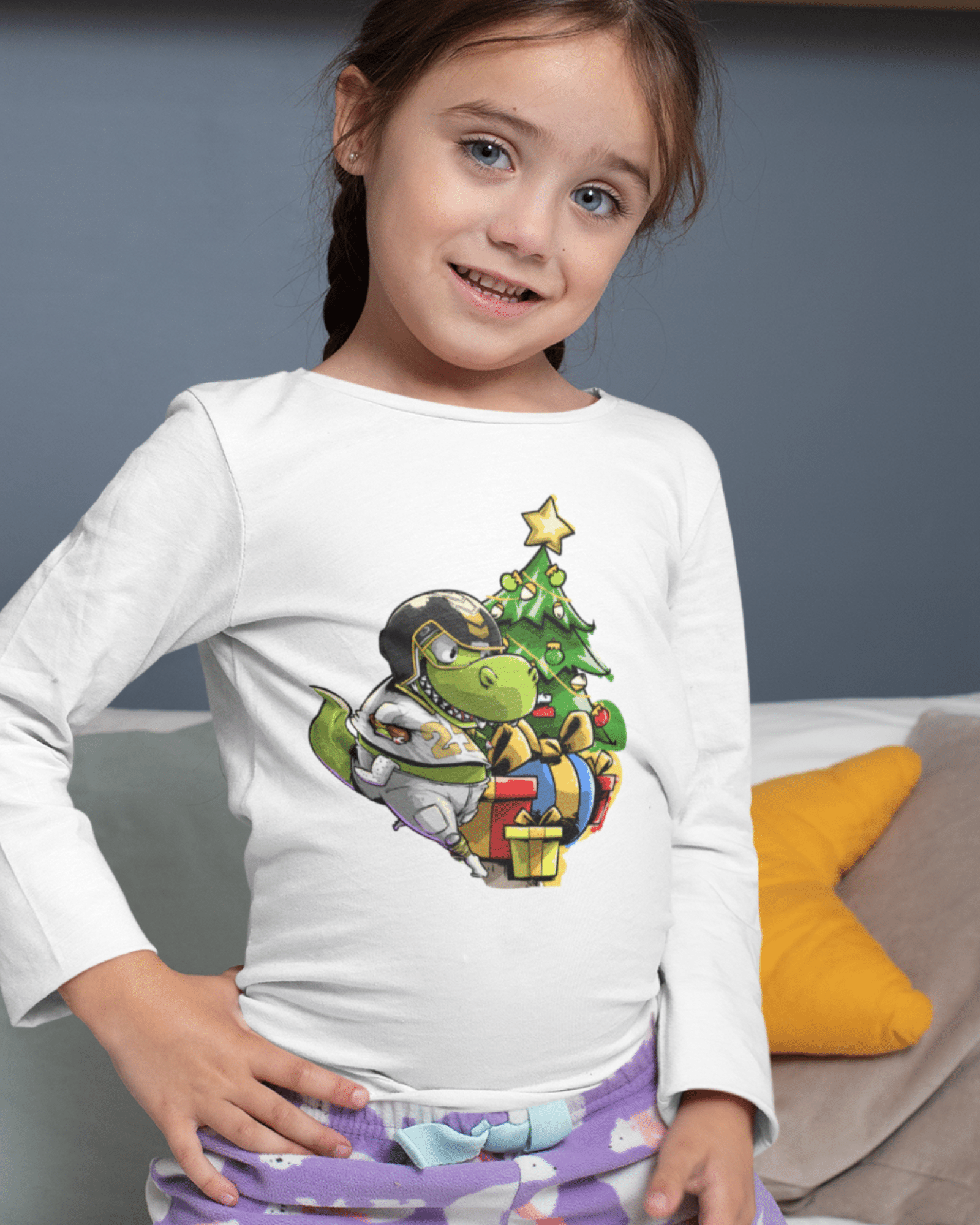girl wearing a christmas football shirt with a dinosaur