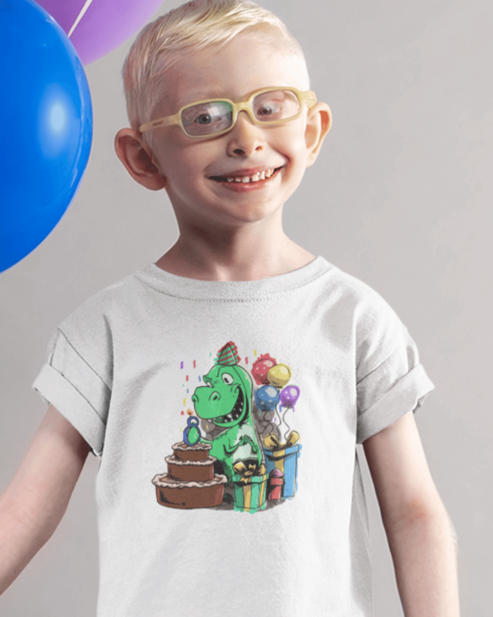 boy wearing a birthday shirt with a dinosaur on it