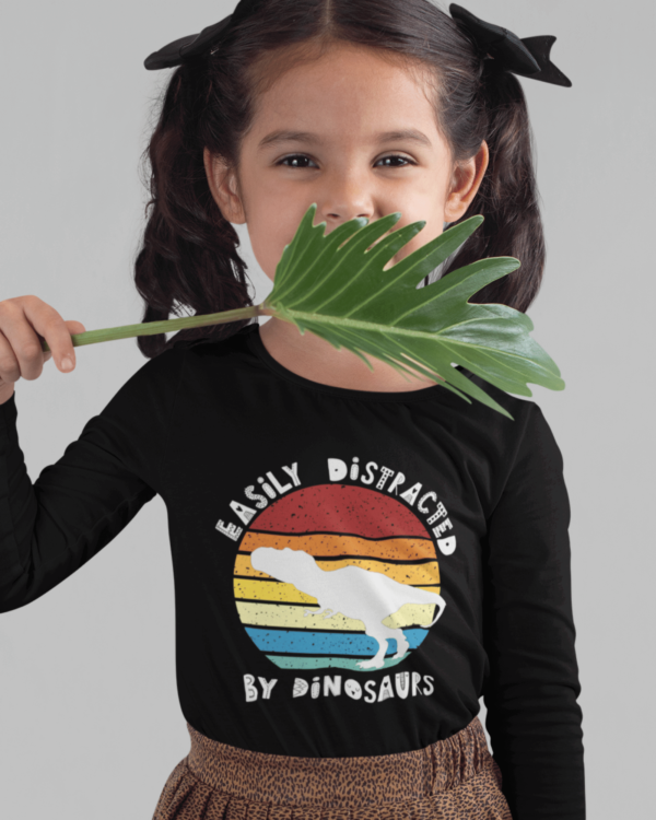 cute girl weaing a dinosaur t shirt