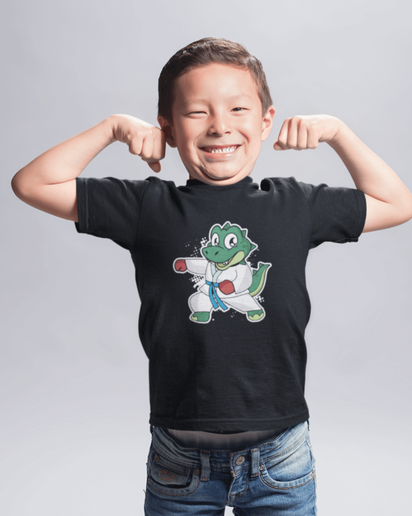 photo shows a young boy wearing a dinosaur martial arts shirt