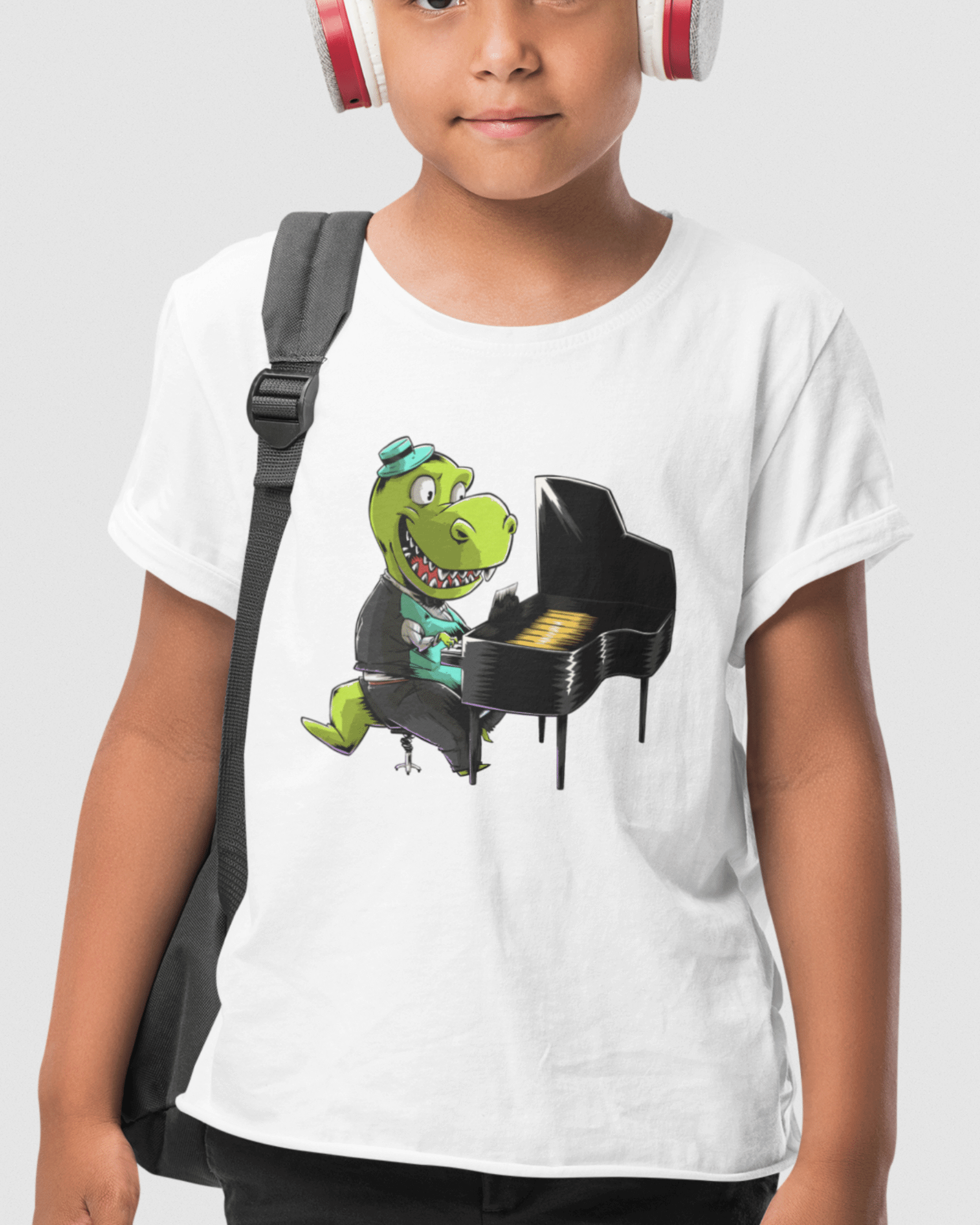 photo shows a boy wearing a shirt with a pianlo playing dinosaur